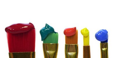 paintbrushes with primary colors paint on them
