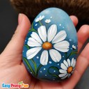 daisy painted on a rock